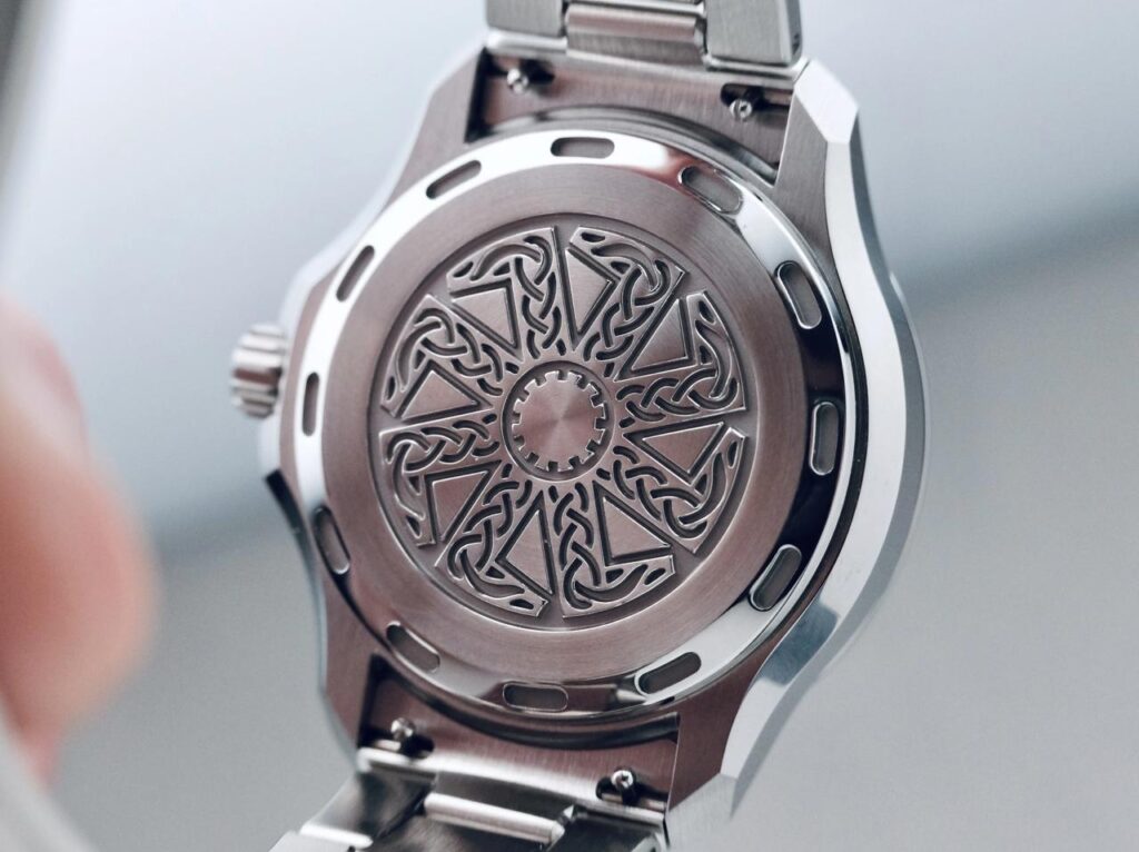 Veles caseback engraved with the kolovrat sun wheel
