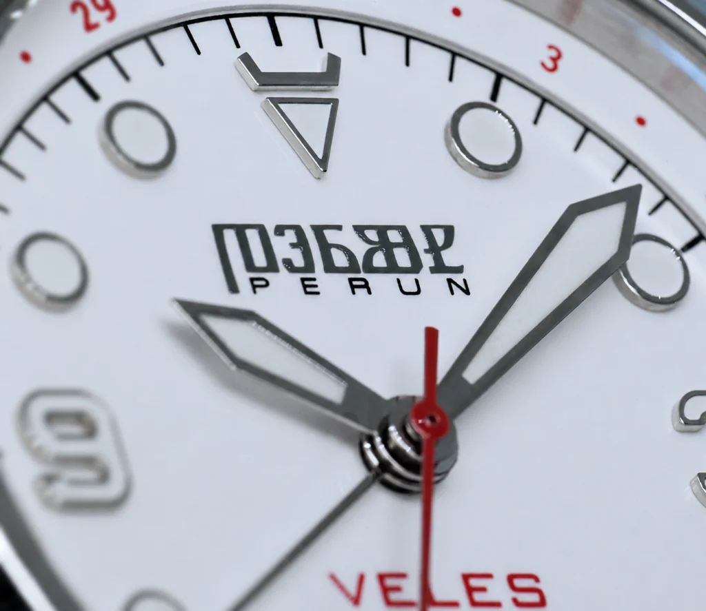 Veles dial close-up: the horns marker at 12 and the Perun wordmark