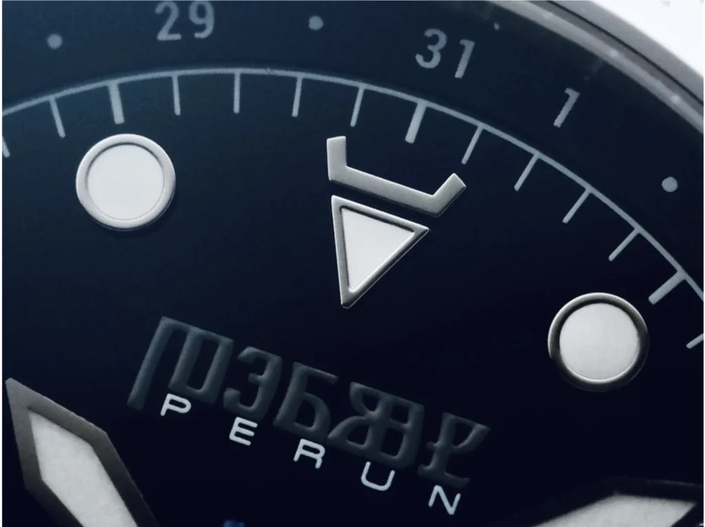 Veles dial close-up: the horns marker at 12 and the Perun wordmark