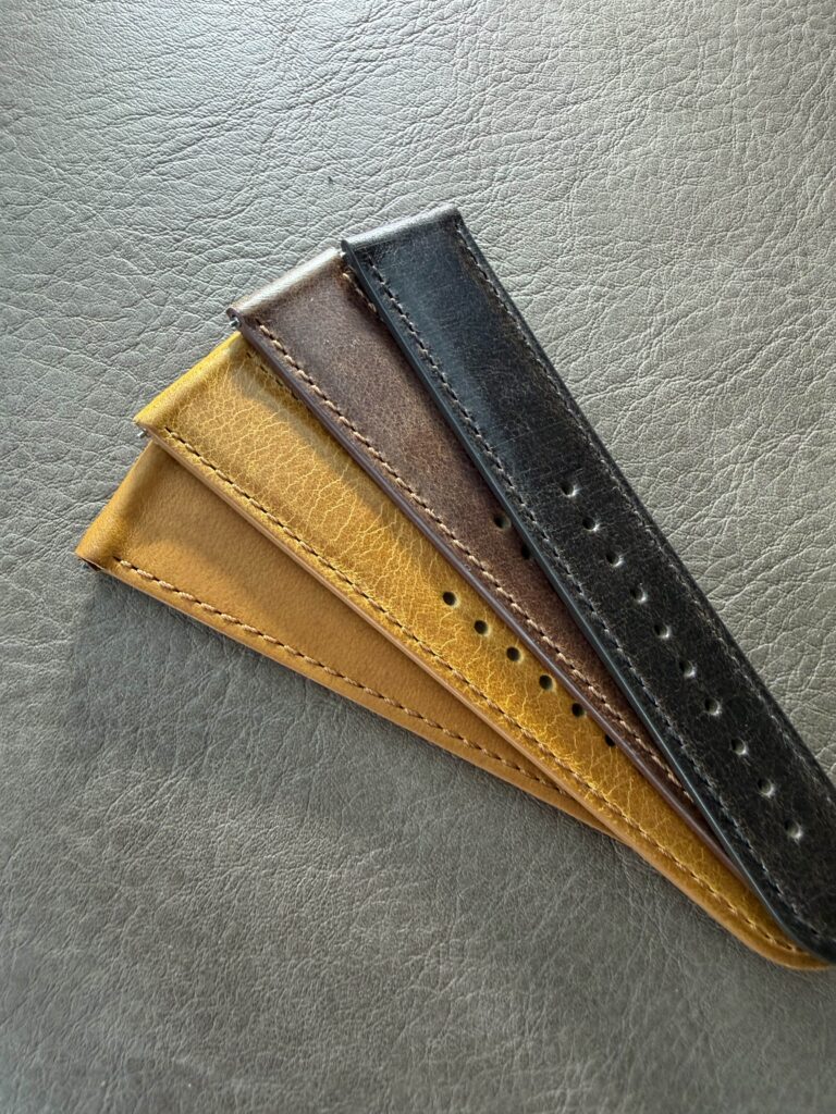 Three Perun leather straps: cognac, light grey and black