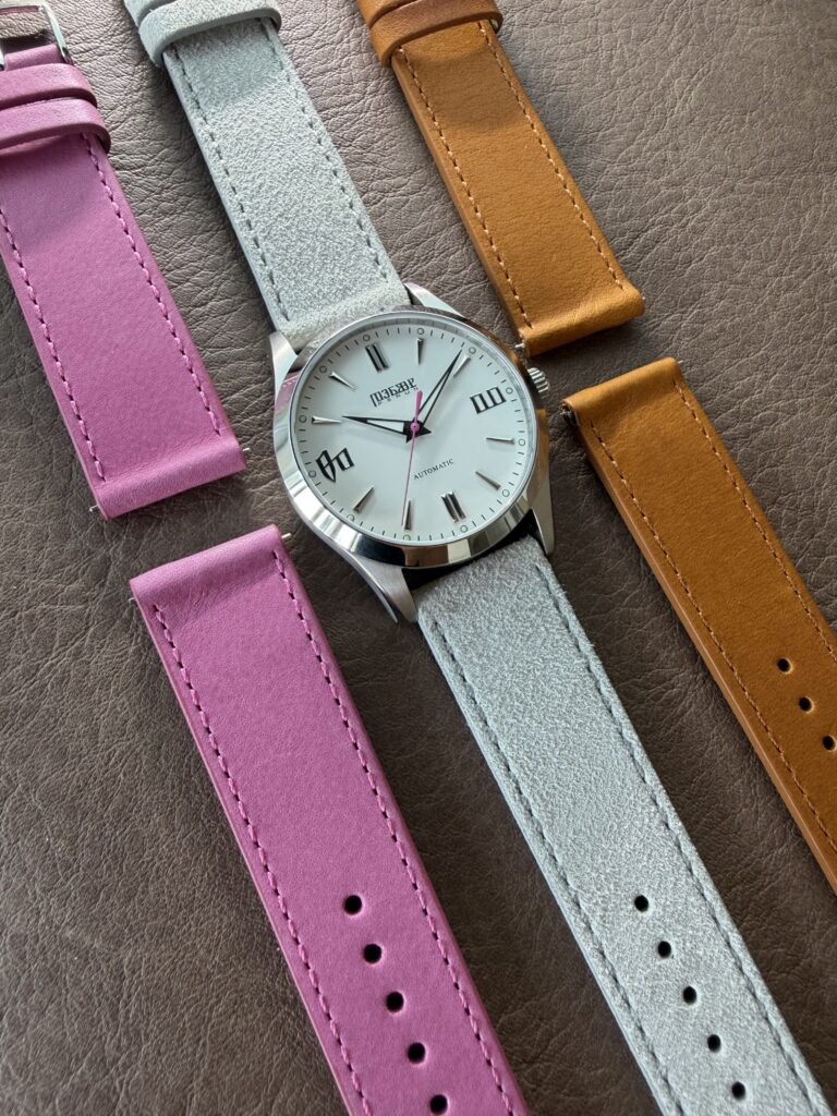 Knez Zora laid out with pink, light grey suede and cognac straps