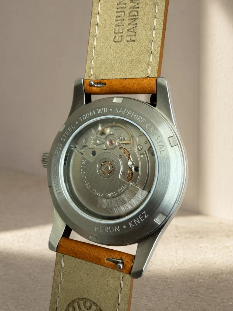 Knez sapphire exhibition caseback with the Swiss automatic movement and its rotor in view.