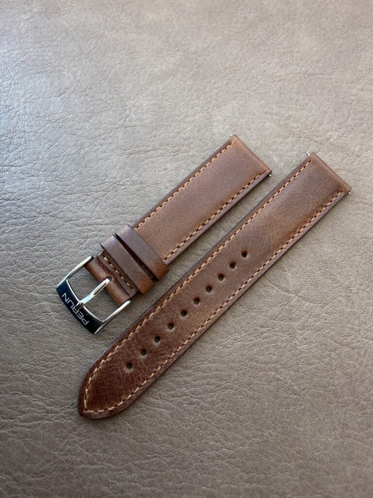 Brown leather strap on a leather backdrop