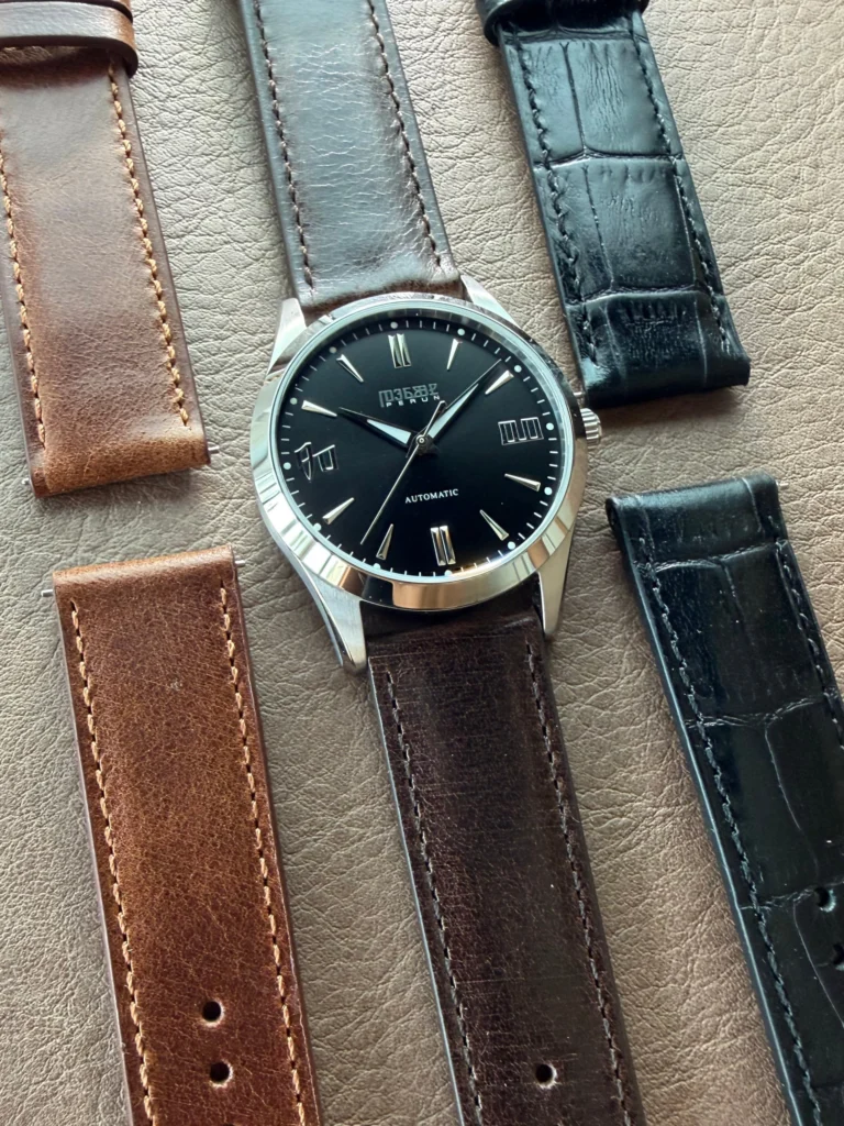 Knez Ponor laid out with brown, black and blue croco leather straps