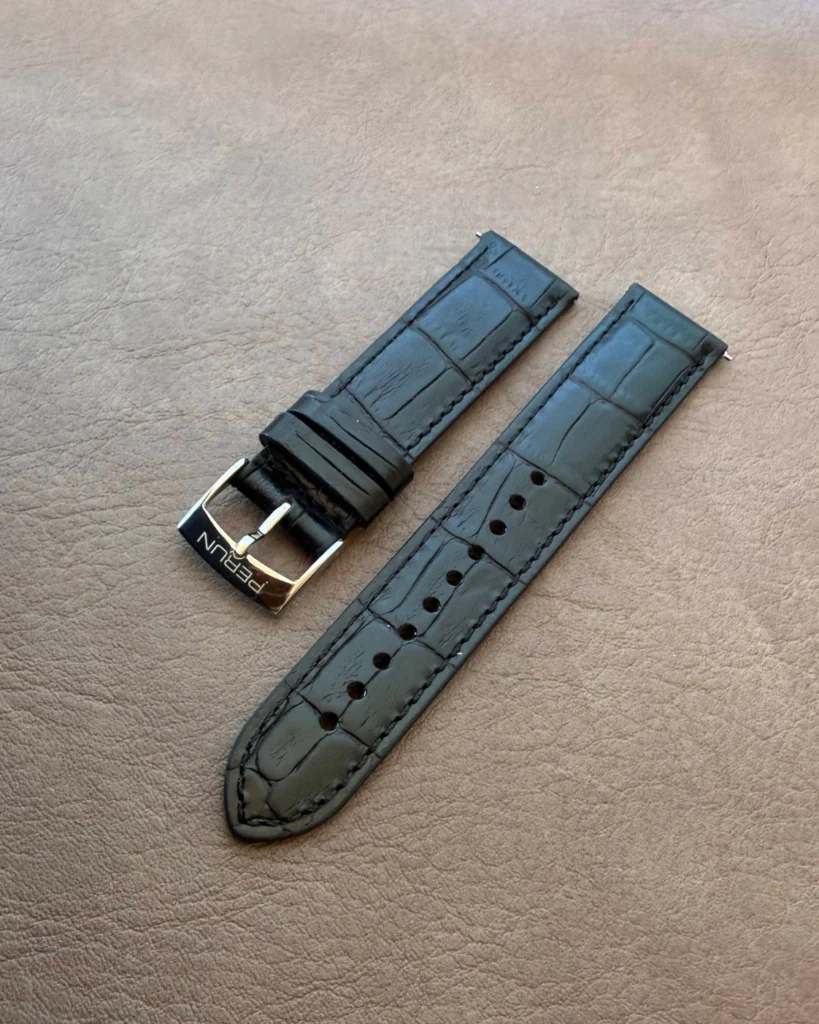 Black croco leather strap on a leather backdrop
