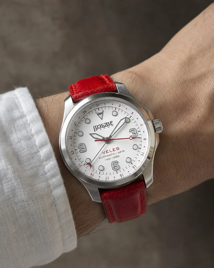 Veles Pearl White on the wrist, on a crimson leather strap