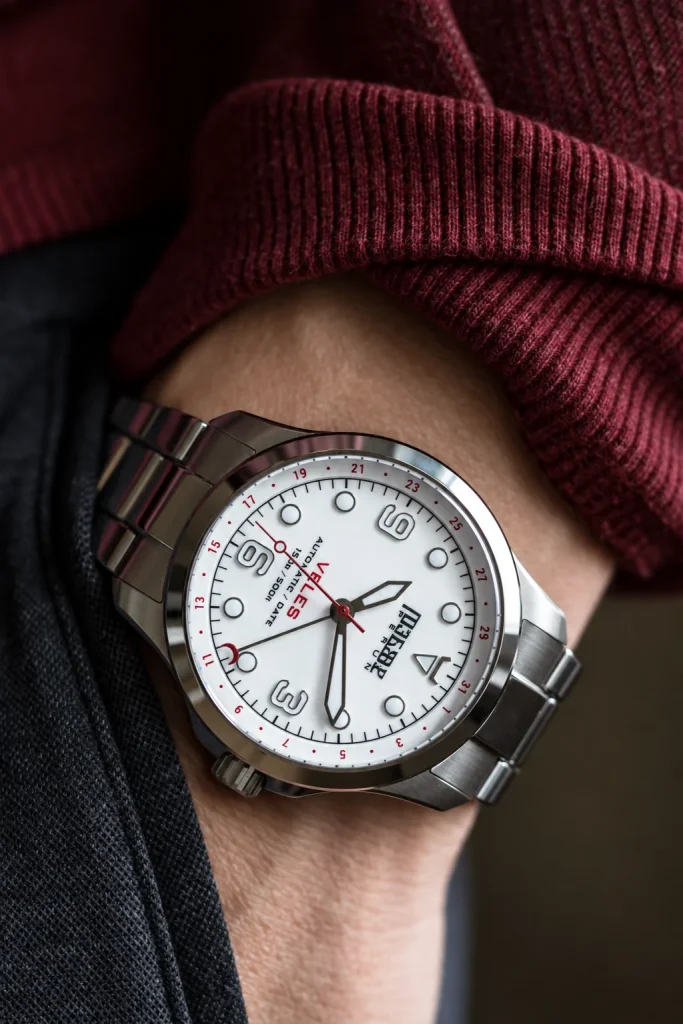 Veles Pearl White on the wrist with a burgundy sweater sleeve